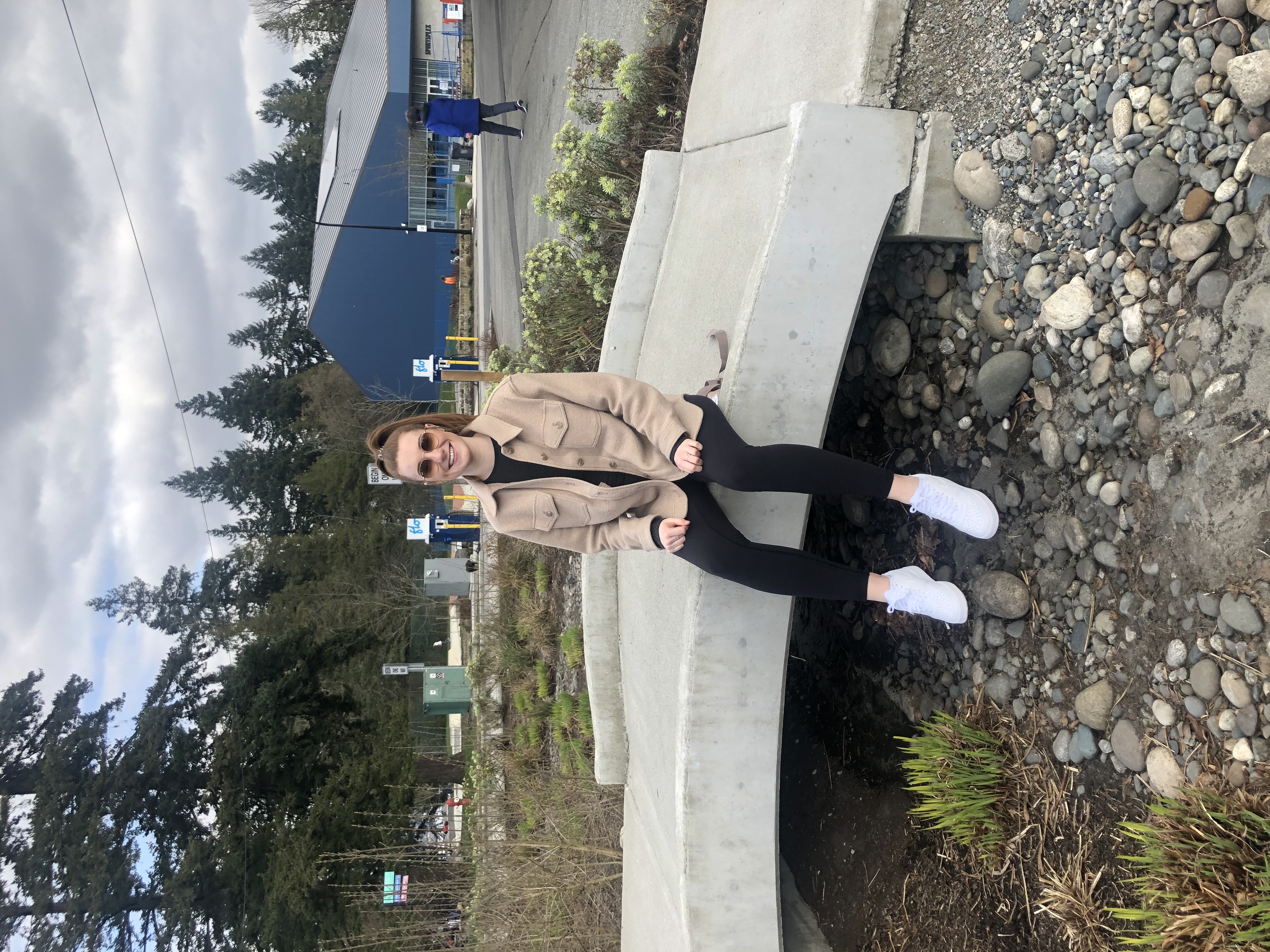 woman sitting on bridge