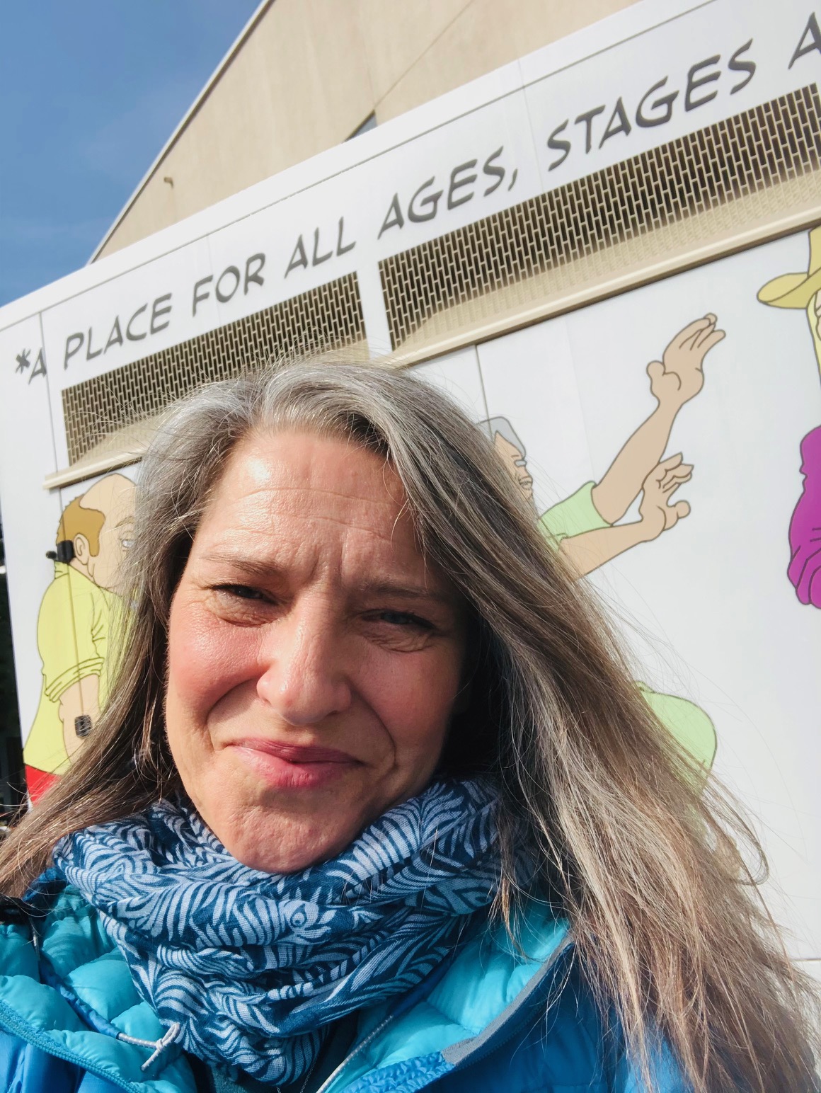 woman smiling with art behind her