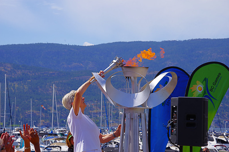 Elderly Woman Lighting Torch