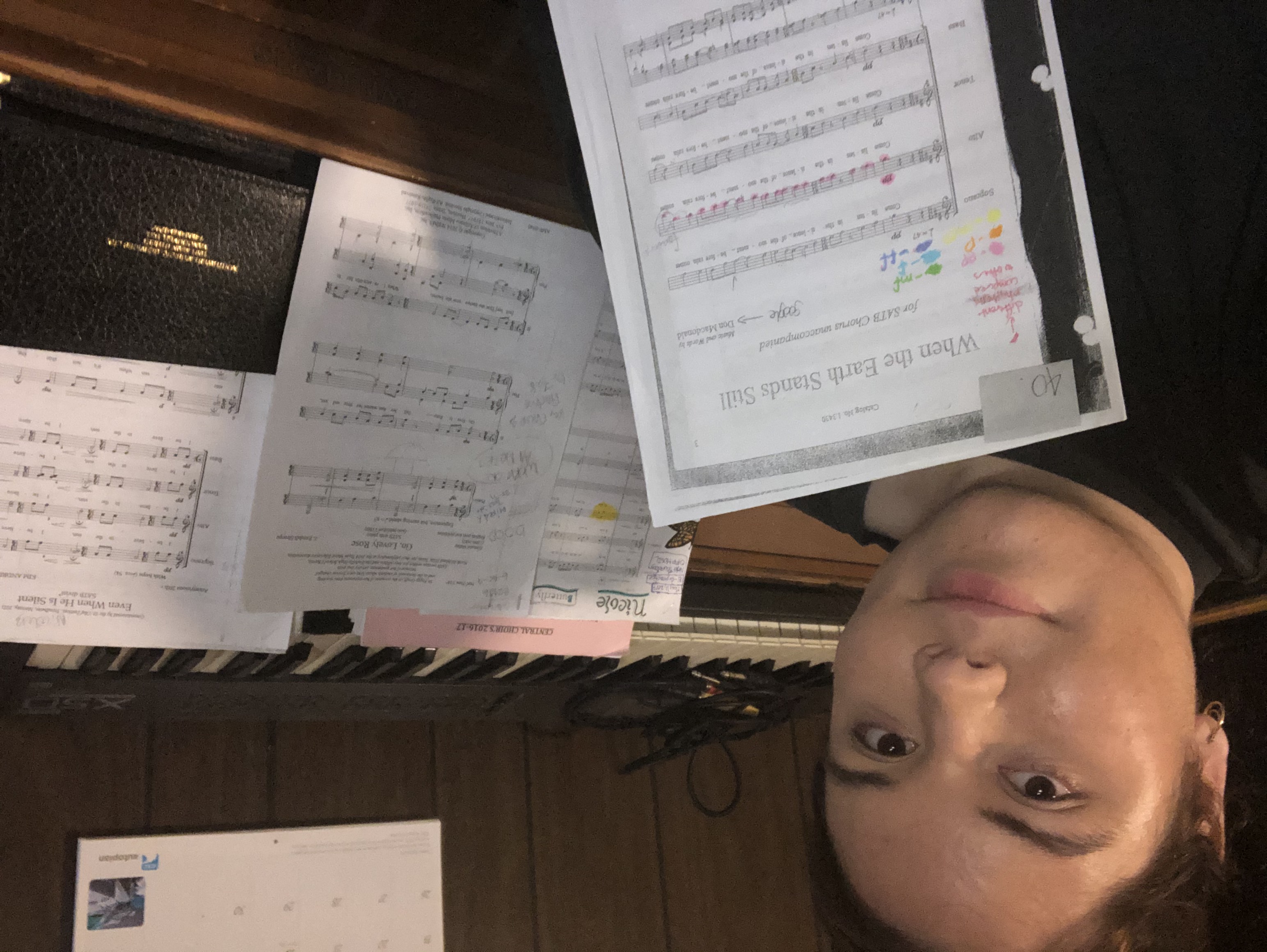 woman beside piano with sheet music