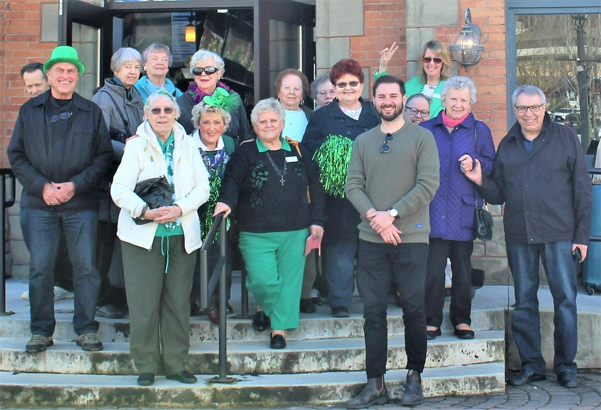 Man posing with seniors dressed in saint patricks day attire