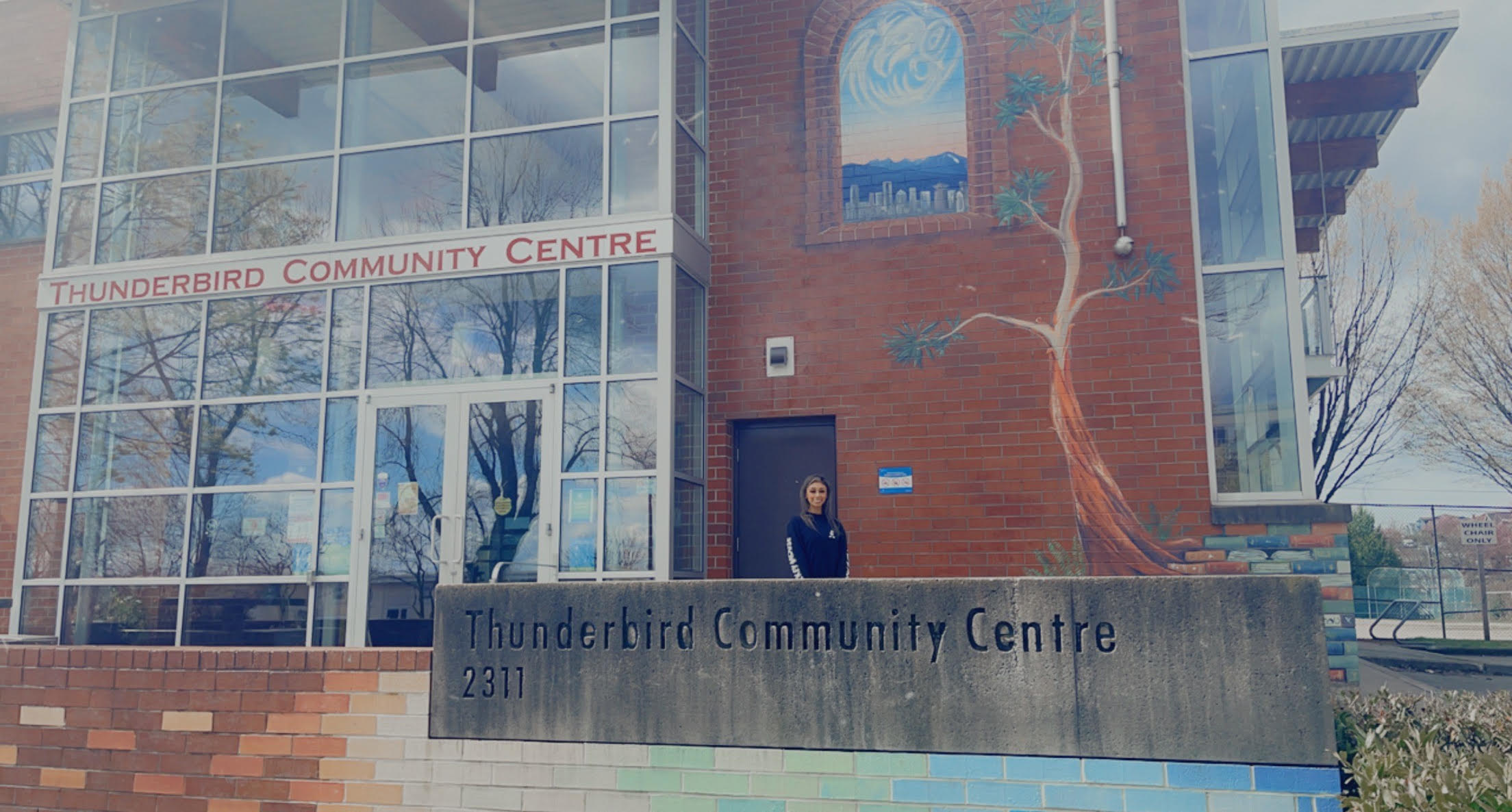 Woman smiling outside of a recreation center